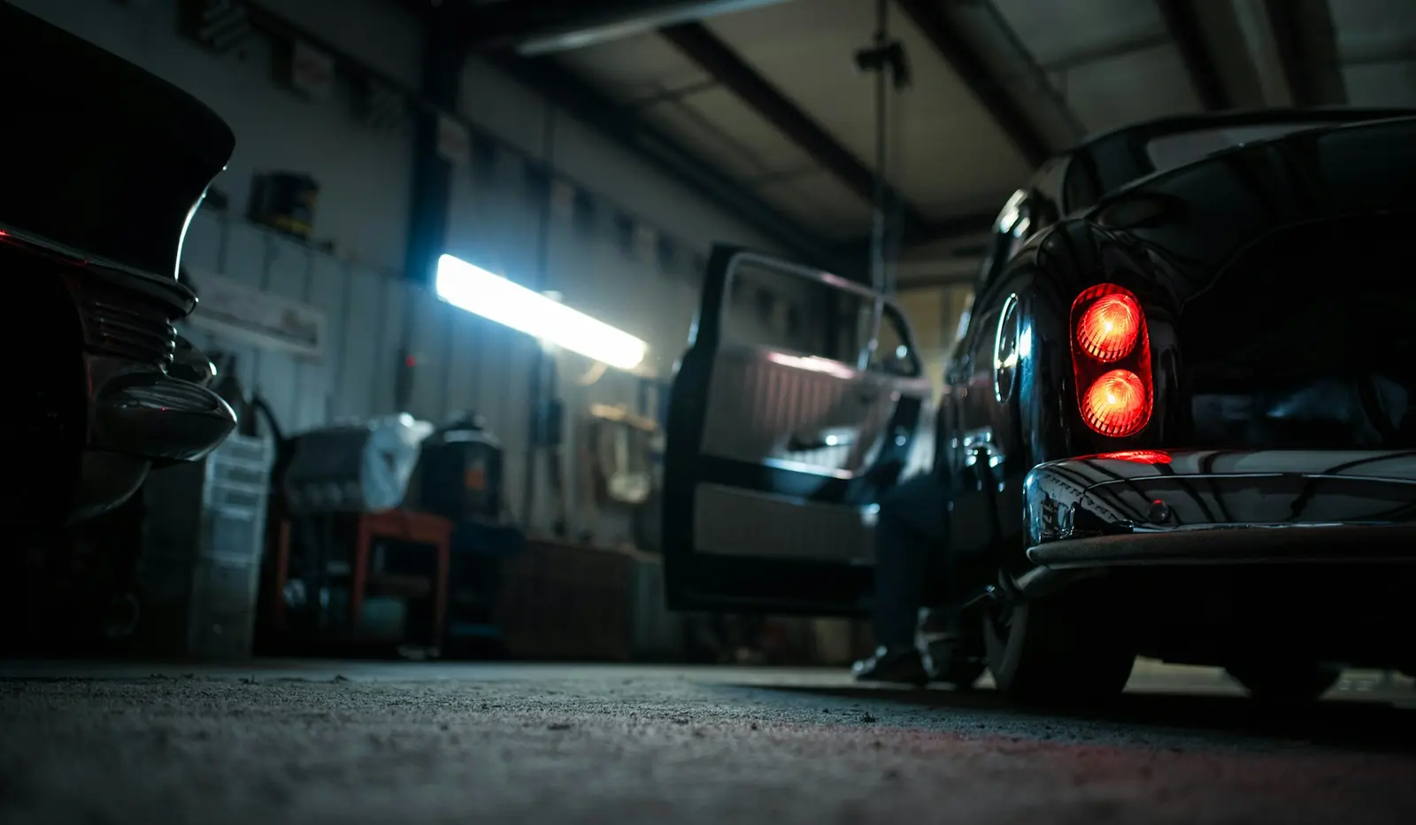 Auto repair shop bay with vehicles on lifts and tools